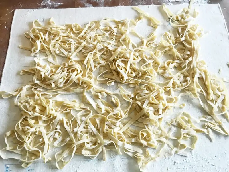 Cut egg noodles left out to dry on a pastry cloth - all ready to complete your homemade beef and noodles