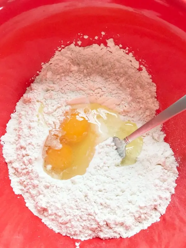 Making homemade egg noodles flour and eggs in bowl