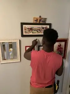 My son hanging pictures