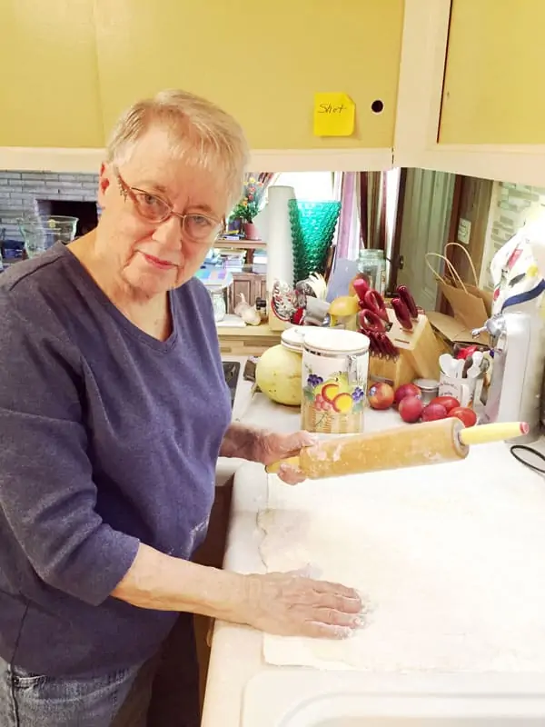 Mom smiling while showing me how to make noodles. 
