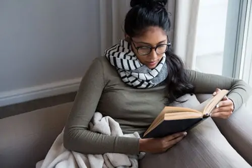 South Asian woman reading a book 