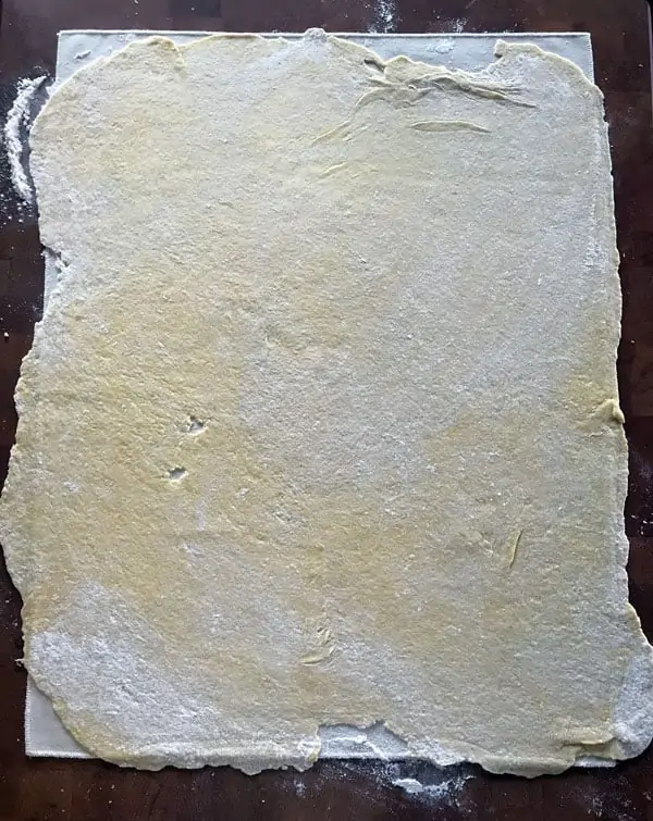 Roll the noodles out as big as the cloth will allow.