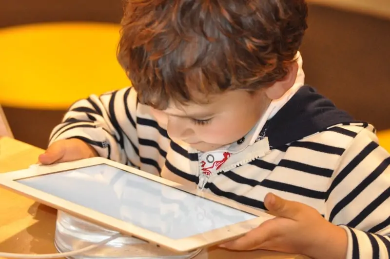 Photo by NadineDoerle--1421566
Litte boy reading a multicultural children's book on a tablet. Latinx