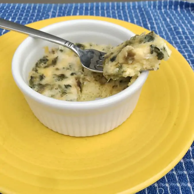 Fork of broccili and cheese frittata above baked dish