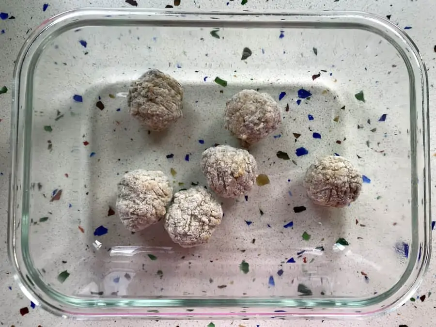 Frozen meatballs in a glass dish