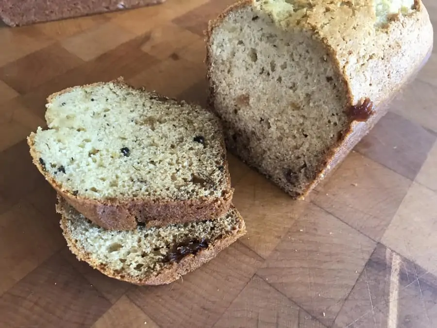 Date bread loaf and slices on cuttin gboard