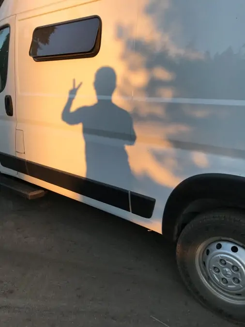 Sunset shadow on van showing peace sign