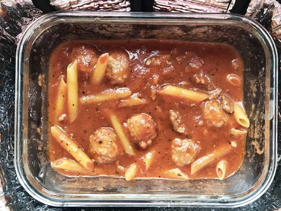 Submerging pasta beneath cooked sauce