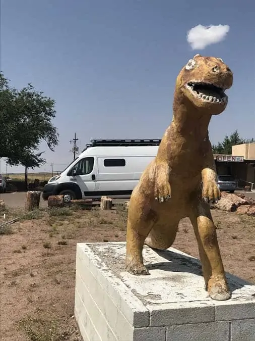 Promaster van behind dinosaur statue