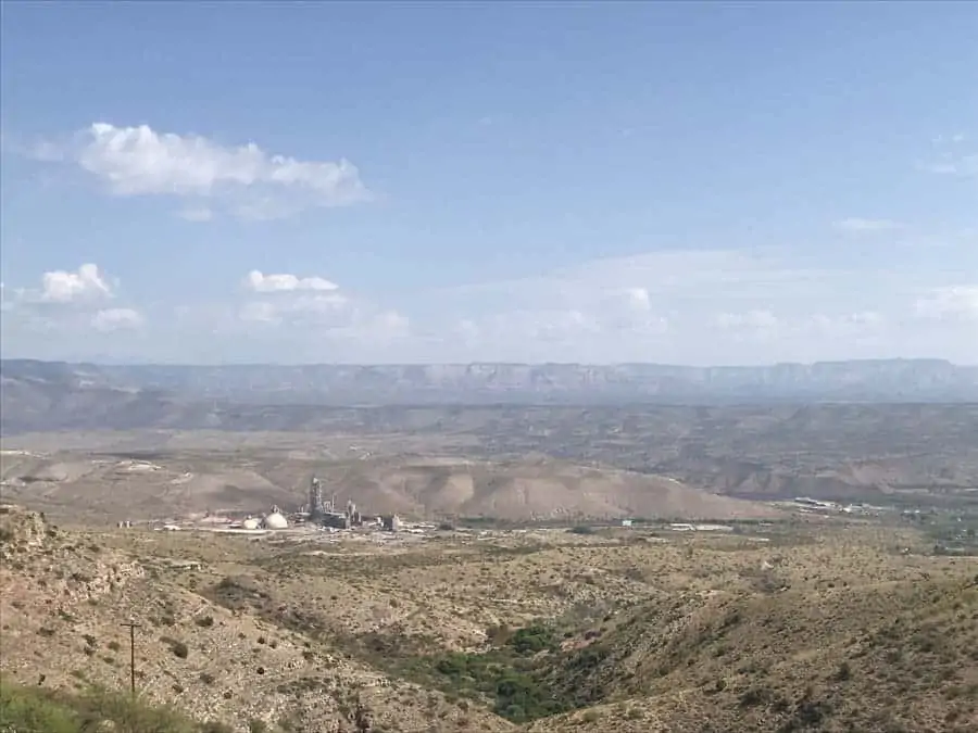 View of valley from Jerome, Arizona showing steep hiils and power plant.