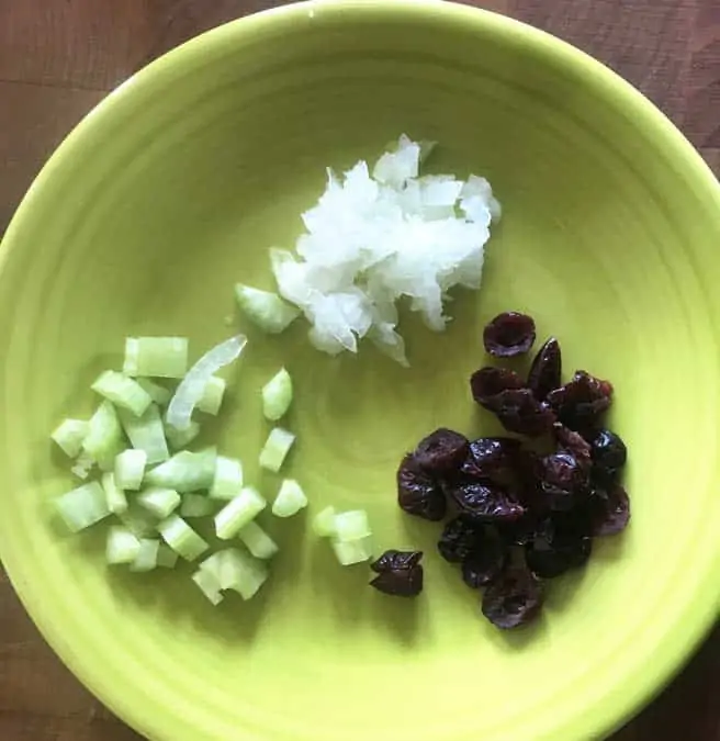 Diced celery, grated onion and craisons on a plate